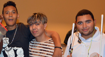 Teenagers smile together for a photo at an NFB national convention in Orlando, Florida.